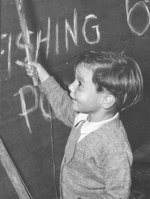 Photograph, A young member of the Morffew family tries his luck at the Lucky Dip at the East Ringwood Pre-School Fair. Date unknown - prior to decimal currency introduction in 1966