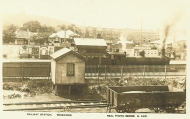 Photograph, Ringwood Railway Station, including view of platform advertising, Main Street shops, and Loughnan's Hill. c.1925