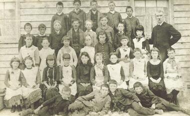 Photograph, Mr. E. F. Cass and pupils at Ringwood's first school - Cass State School 1451, located at corner Everard Rd. & Maroondah Highway - 1883.  Mr. Cass was Head Teacher at the school 1874-1894