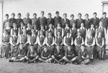 Photograph, Ringwood High School - 1954, Form 2A.  Boys standing (L-R): 1. David Reese, 2. Robert Gruar, 3. Ray Cornell, 4. Ken Tuppen, 5.Eric Brooks, 6. John Allsop, 7. David Lyall, 8. Ray Horsey, 9. Robert Finnis, 10. John Murnane, 11. Victor Greenham, 12. David Storrar, 13. Andrew Sprogis, 14. Volkar Sawatsky. Girls standing: 1. ?, 2. Norma Traverton, 3. Leslie Gibson, 4. Valerie Noble, 5. Margaret Rankin, 6. Merle Kneebone, 7. Noelene D'Hurville?, 8. Dorothy Hancock, 9. Lorraine Smith, 10. Shirley Dobson, 11. Iris Allen, 12. Janice Garrett, 13. Heather Anderson.  Girls seated: 1. Wendy Hatfield, 2. Ruth Beveridge, 3. Glenda Hall, 4. Dawn Simpson, 5. Jeanette Melville, 6. Margaret Buck, 7. Anne McDowell, 8. Jennifer Pickford, 9. Judith Nott, 10. Lilian Thompson, 11. Margaret Denis.  Boys seated: 1. Barry Ring, 2. Ashley Barker, 3. Louis Stevenson, 4. Terry Drummy, 5. Ian Chambers, 6. Ian Morris