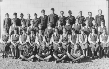 Photograph, Ringwood High School - 1954, Form 1B.  Boys standing (L-R): 1. Peter Hodgson, 2. Peter Fry, 3. Ralph Stoel. 4. Kevin Kane, 5. Terry Dicini, 6. Rod Young, 7. Colin Warren, 8. Michael Cotter, 9. Daryl Pike, 10. Gordon Schultz, 11. Sid Gruar, 12. Neil Reid.  Girls standing: 1. Carol Maggs, 2. Susan Libby, 3. Barbara Hill, 4. Leonie Stirling, 5. Dalia Karvellis, 6. Margaret King, 7. Pam Daniels, 8. Marjorie Reynolds, 9. Barbara Holden, 10. Nancy McDonald, 11. Lyndal Keene.  Girls seated: 1. Margaret Vergers, 2. Juan Harris, 3. Wendy McIntyre, 4. Lorraine Norman, 5. Lynette Reid, 6. Anne Whitehouse, 7. Dulcie Ellis, 8. Carol Bruce, 9. Margaret Seamon, 10. Nola Burns, 11. Ruth Chandler, 12. Janice Mills.  Boys seated: 1. Barry Wedlock, 2. Gordon Bould, 3. Ken Baker, 4. Bill Mann