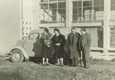 Photograph, Group with car outside Merlin Confections, Ringwood. Undated, possibly c1951