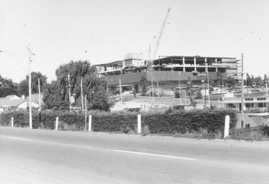 Photograph, Eastland under construction, looking across bowling green - 4/3/1973