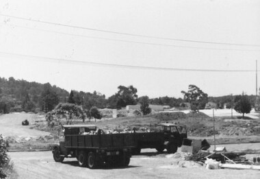 Photograph, New market - Truck clearing portion of Billy Guyatts building to make way for new road. 1982