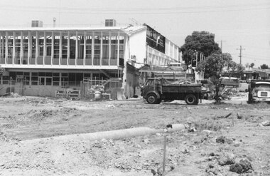 Photograph, New market - Work on Ringwood's new street showing men demolishing part of Billy Guyatts buildings. 1982