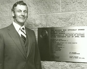 Photograph, Official opening of the Karralyka Centre, Mines Road, Ringwood on 19/4/1980 - Alan Robertson, City Engineer, standing next to plaque for the official opening by His Excellency Sir Henry Winneke, Governor of the State of Victoria, on the nineteenth day of April 1980, 19-Apr-80
