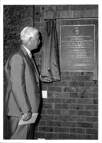 Photograph, Sir Rohan Delacombe, Governor of Victoria, standing by plaque after unveiling at the opening of Ringwood Civic Centre 28-Jan-1970