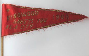 Memorabilia - Flag, Red flag on stick with gold border and lettering imprinted: "Ringwood Greets You as a City 1960", 1960