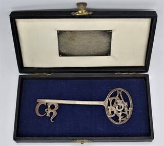 Memorabilia - Key in Box, Metal ornamental key in white silk and blue velvet lined black presentation box, with plaque inscribed: "Presented to R.A.E. 3 Div by the Council of the City of Ringwood on the occasion of granting of the Freedom of Entry to the Municipality 27th March, 1966, 27-Mar-66