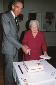 Photograph, Ellie Pullin & Ralph McDonell cutting the 30th Ringwood Historical Research Group birthday cake at Ringwood Elderly Citizens Hall on 20th August 1988, 1988