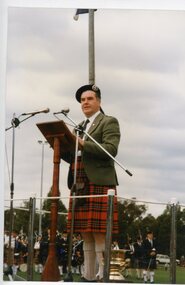 Photograph, Ringwood Highland Games -1998. Speaker at rostrum.(unidentified)