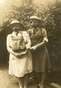 Photograph, Doris and Ruby Oke testing breathing apparatus with the ARP during WWII
