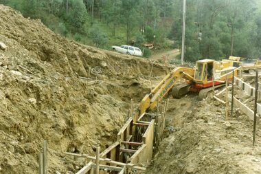 Photograph, Kubis Estate, North Ringwood on 16 June 1978. Kato working on final trench. The hole for the 27 feet deep well is seen beyond the trench