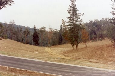 Photograph, Loughnan Lake site over Kubis Drive, North Ringwood, on 14 April 1978. The retaining wall was where the car tracks disappear over the ridge where the spillway was