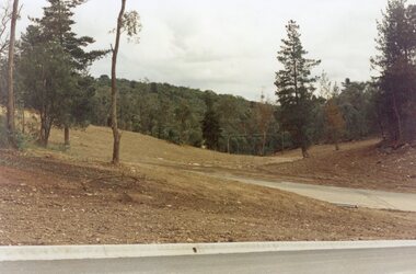Photograph, Looking west across Werac and Kubis Drives, North Ringwood, in April 1978. Loughnan's Lake site. The retaining wall was where the truck tracks disappear over thhe ridge. The spillway was at that spot