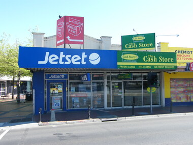 Photograph, 151-155 Maroondah Highway, looking north, in 2008. Showing Jetset travel agency, the Cash Store and Chemist Warehouse. Now demolished for REALM Library