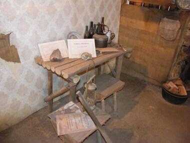 Photograph, Showing the living rooms of the facsimile of the miner's hut, located at the back of Ringwood Lake, from the original that once stood on Maroondah Highway in the 1870s onwards. The cottage was erected by the Ringwood City Council in conjunction with Ringwood Historical Research Group (now Ringwood & District Historical Society). Officially opened by Mayor Cr Pat Gotlib JP on 29th May 1983