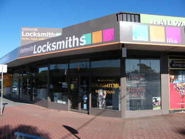 Photograph, South-east corner of 6 Railway Place. Showing Statewide Locksmiths
