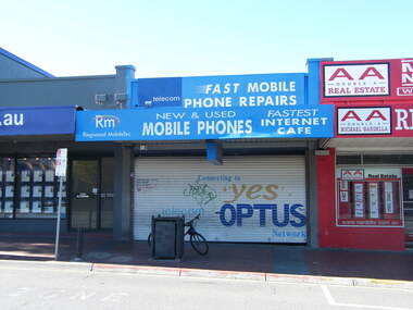 Photograph, Maroondah Highway, Ringwood showing Michael Nardella real estate, Carter real estate and mobile repairs business