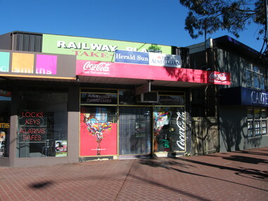 Photograph, East end of Railway Place, Ringwood near the former entrance to the railway station, showing locksmith, cafe and Carter real estate