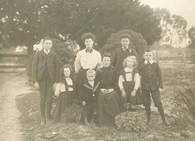 Photograph, Mrs Sherburn and family in garden in front of cottage, Ringwood, late 1800's