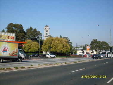 Photograph, Corner of Maroondah Highway and Wantirna Road looking south-west, Ringwood on 21 April 2009.  Memorial Clocktower, Haymes Paint and Johnny Boys Pizza