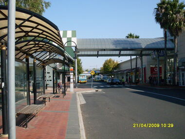 Photograph, Looking along Eastland access road looking west, on 21 April 2009. Showing bus stop and entrance to Eastland