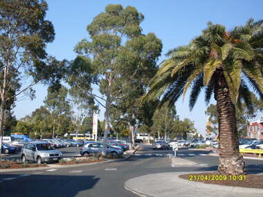 Photograph, Looking along former Adelaide Street, from the access road roundabout, towards the south, on 21 April 2009. Showing bus terminus on the other side of the highway, at the station