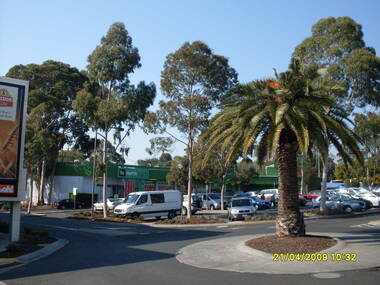 Photograph, Looking along former Adelaide Street, from the access road roundabout, towards the south-east, on 21 April 2009. Showing bus terminus on the other side of the highway, at the station, and former Harris Scarfe store