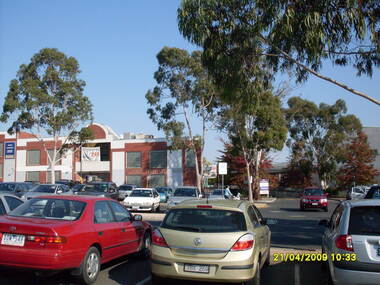 Photograph, Looking across stage 4 Eastland carpark, towards the south-west, on 21 April 2009. Showing strip of shops opposite the Ringwood Station