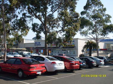 Photograph, Looking across stage 4 Eastland carpark, towards the north-west, on 21 April 2009. Showing the car park entrance and front Eastland shops