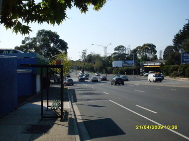 Photograph, Looking east along Maroondah Highway with bus stop on left and Warrandyte Road railway underpass on right, on 21 April 2009
