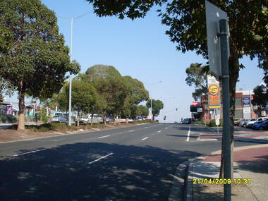 Photograph, Looking west along Maroondah Highway with Ringwood Railway Station on left and shops on right, on 21 April 2009