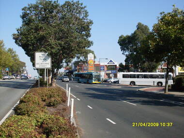 Photograph, Looking west along Maroondah Highway with Ringwood Railway Station on left and entrance to Eastland car park and shops on right, on 21 April 2009