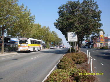 Photograph, Looking west along Maroondah Highway with Ringwood Railway Station and bus terminus on left and entrance to Eastland car park and shops on right, on 21 April 2009