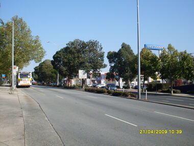 Photograph, West along Maroondah Highway, on 21 April 2009, showing Eastland sign and shops opposite the railway station