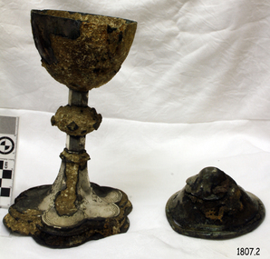 Silver goblet style cup on a pedestal with decorative base and matching lid