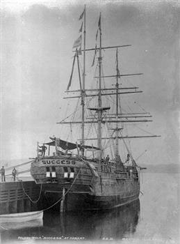 Black and white photograph of a docked Three-masted sailing ship