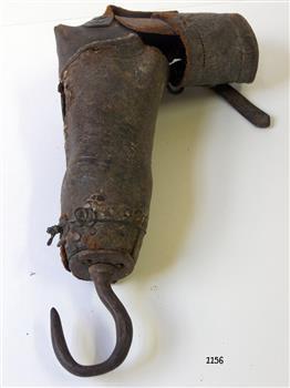 Brown leather arm is bent at the elbow and has a hook where a hand would normally be