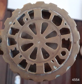 Air intake is a brass grill with punched out holes