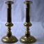 Brass candlesticks with round base and decorative stems.