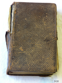 Brown leather cover with crisscross pattern