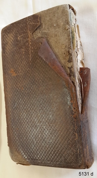 Brown leather back cover with crisscross pattern and spine