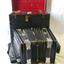 Open, red-lined black case, black and cream accordion in front, opened out
