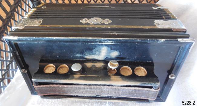 Two out of six of the buttons remain on this end of the accordion, the others are missing