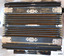 Decorative engraved metal protection and identification. The long narrow trim has an inscription