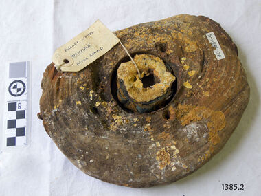 Pulley has holes, encrustations and attached labels