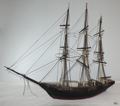 The image shows the whole port side of the ship, so the height of deck structures  can be compared with its hull.