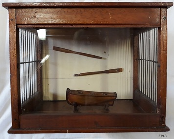 Front is glass, oars are on the back side of the model's case