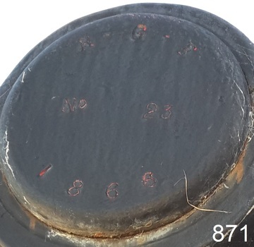 Stamped characters on a round metal plate